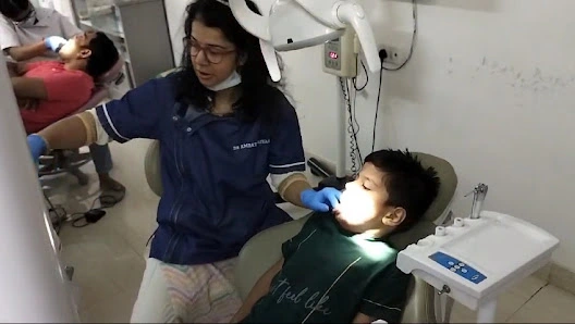 Dr. Amrata treating a young patient with gentle care